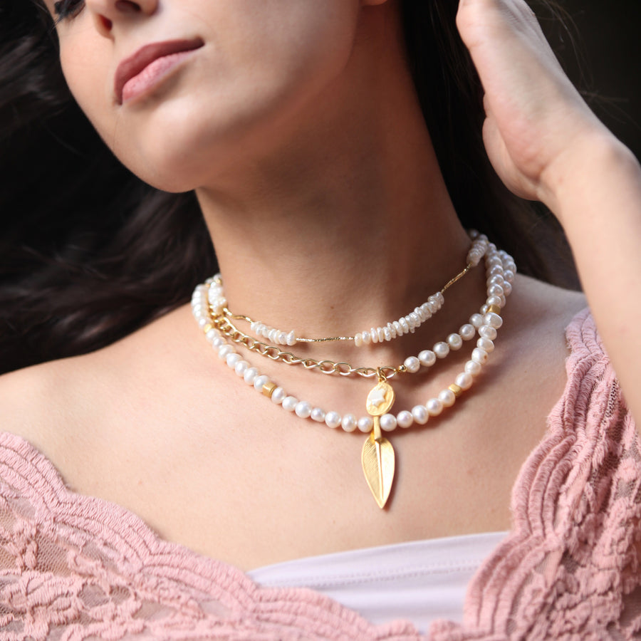 multilayered pearl necklaces star and feather pendants. half chain half pearl . luxury jewelry for cheap prices for a fancy trendy look. outfit ideas 